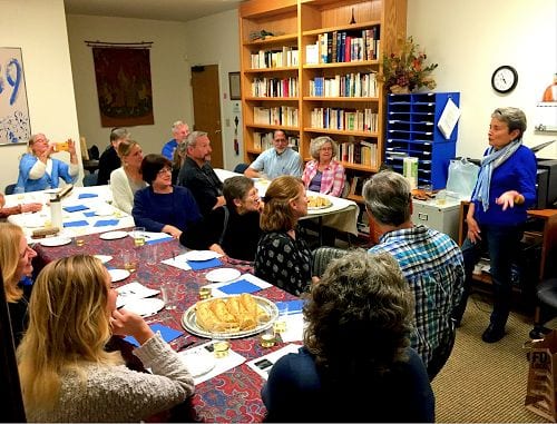 Say Fromage people in a conference room with speaker