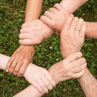 Volunteers Photos of hands clasped around each others' wrists to help out